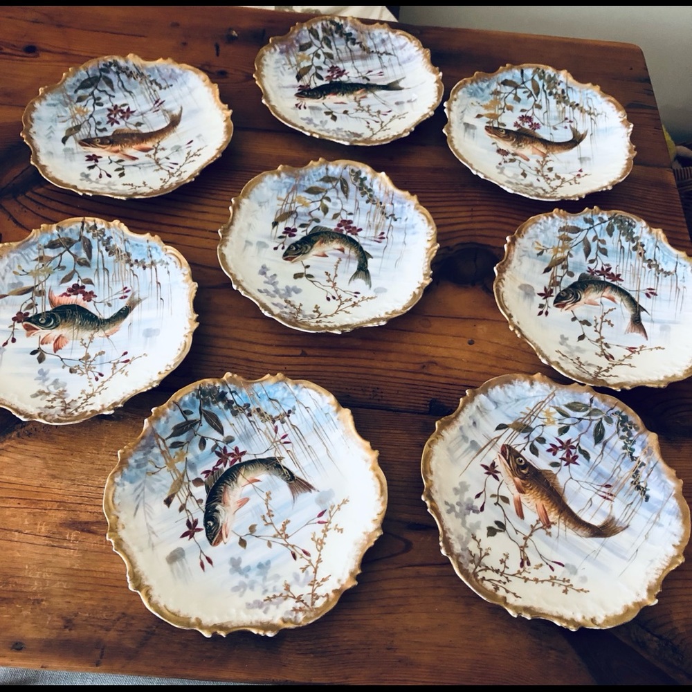 Eight antique Limoges plates with fish design